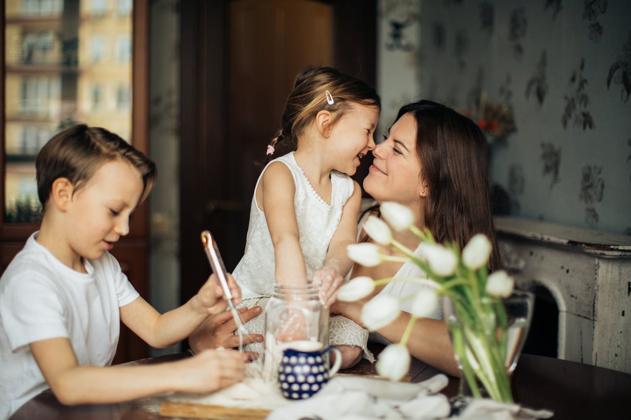 A joyful moment of a mother baking with her children in a cozy home environment.